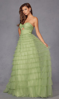 A woman in the Long Prom Dress JT2456H by Juliet, a light green strapless ball gown with ruffled tulle, tiered skirt, and waist cutout, stands against a plain gray background.