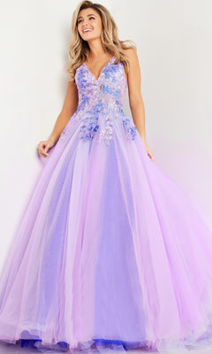 A woman wears the Jovani Lilac Purple Long Prom Ball Gown 24602, a floor-length dress with floral appliqués and an embroidered bodice, standing against a light background.