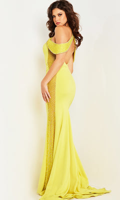 Model in the Jovani Sheer-Illusion-Sides Long Prom Dress 24611, featuring a form-fitting yellow off-the-shoulder design with beaded side panels and draped straps, poses against a plain light background.