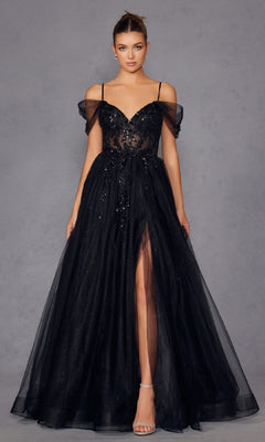 A woman wears the Sheer-Waist Long Prom Ball Gown, Juliet JT2466A, a black off-the-shoulder dress with sequin details and a thigh-high slit, styled in a ball gown silhouette, standing against a plain gray background.