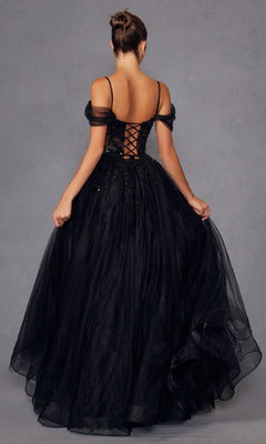 A woman stands with her back to the camera, showcasing the Juliet JT2466A Sheer-Waist Long Prom Ball Gown—an elegant black off-the-shoulder A-line dress with a lace-up corset back and full tulle skirt, perfect for any formal occasion.