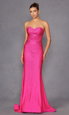 A woman poses against a plain gray background in the Strapless Long Sequin Prom Dress: Juliet JT2472R—a fitted, floor-length hot pink gown featuring a subtle linear pattern and an elegant sweetheart neckline.