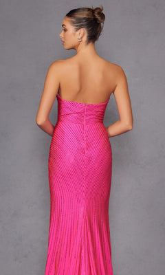 A woman faces away, wearing the Juliet JT2472R Strapless Long Sequin Prom Dress in bright pink, featuring a sweetheart neckline with shimmering vertical and diagonal lines, set against a plain gray background.