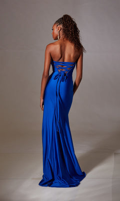 A woman faces away, wearing the Aerie Couture 249 Strapless Long Prom Dress with a corset-style lace-up back and a floor-length blue skirt that flows elegantly against a plain backdrop.