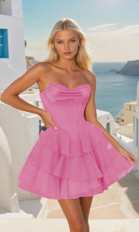 Woman wearing a short bright pink dress with a scenic background