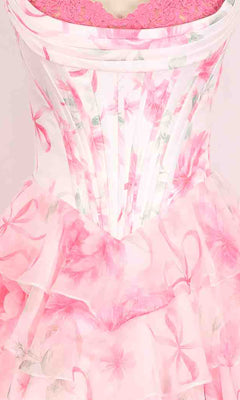 Close-up of the Floral Prom Ball Gown: PromGirl Exclusive 250123D, featuring pink and white florals, sheer ruffled layers, visible boning, and a pink lace undergarment.