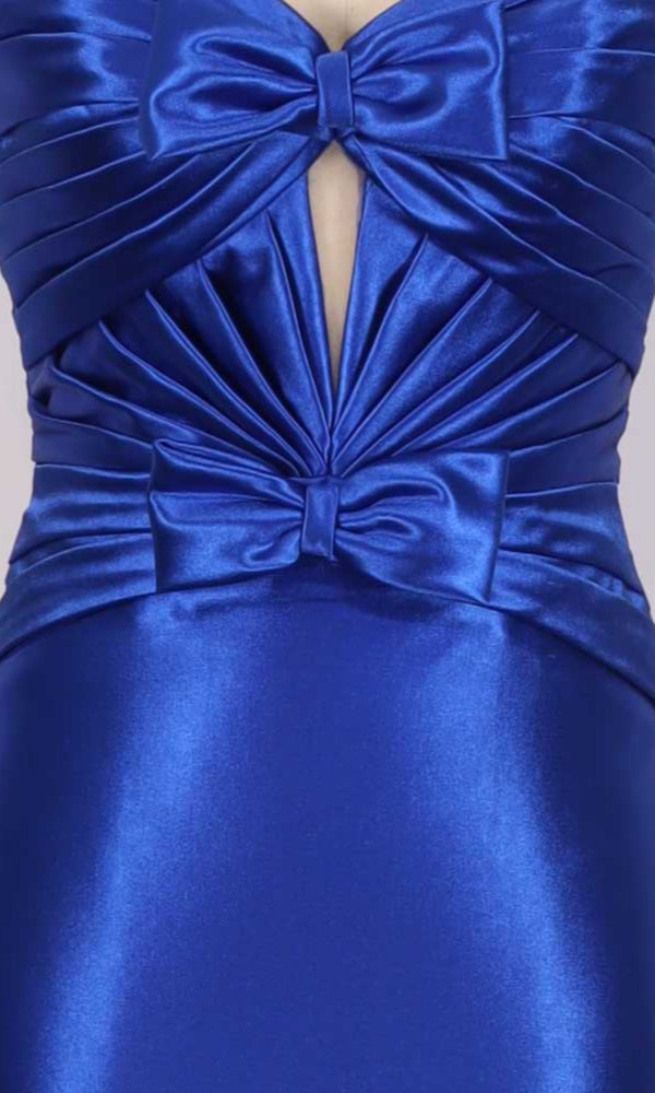 Close-up of a blue satin dress with bow details on a gray background