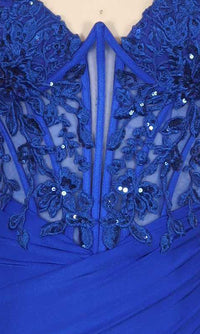 Close-up of a royal blue dress with intricate floral lace embroidery on a sheer corset bodice.