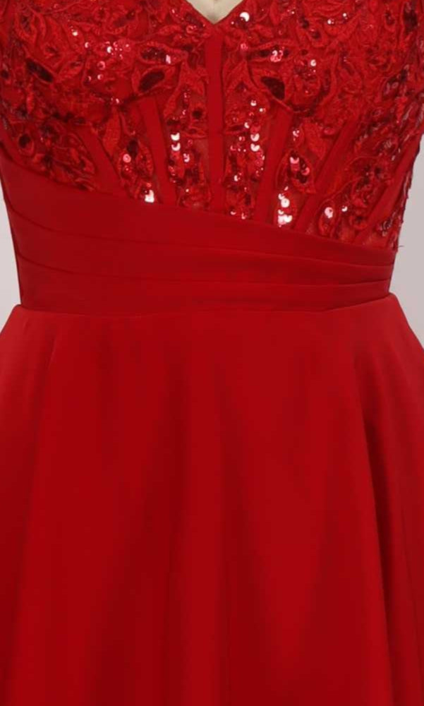 Close-up of red dress with sequin embroidered embellishments on a plain background