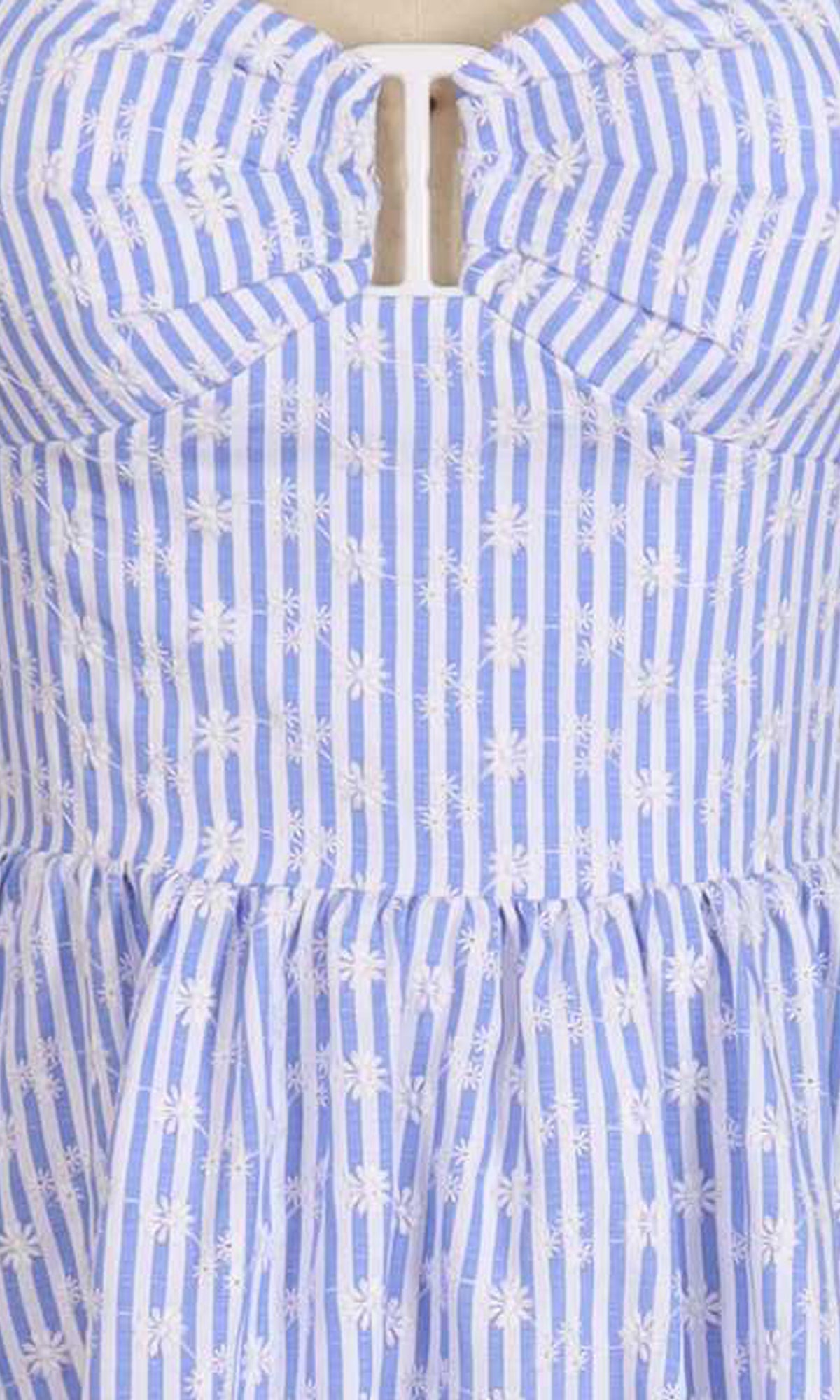 Close-up of a blue and white striped dress with floral patterns