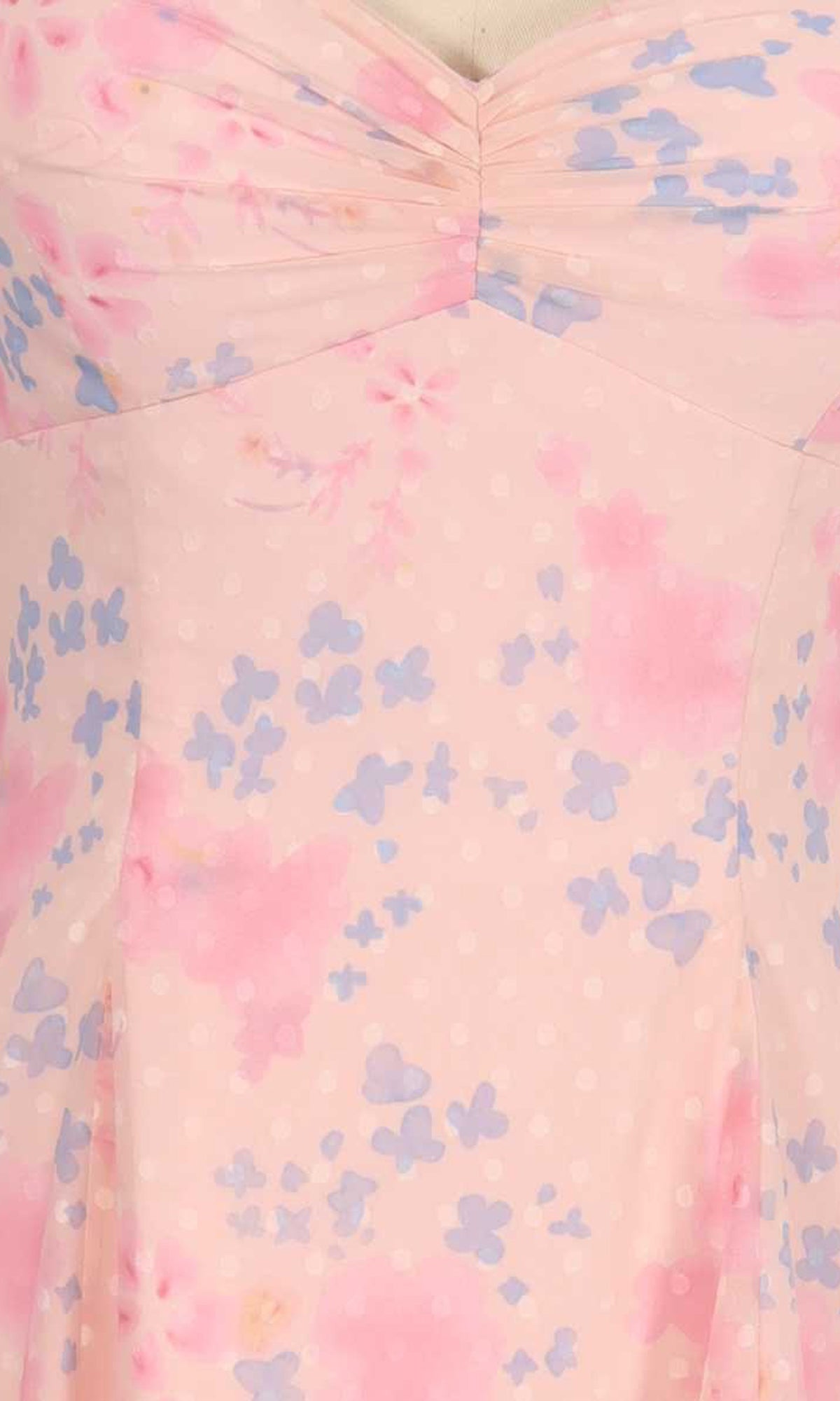 Close-up of a pink dress with blue butterfly pattern