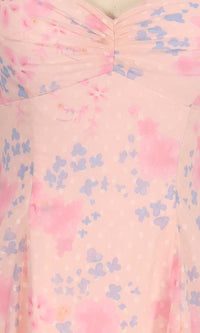 Close-up of a pink dress with blue butterfly pattern
