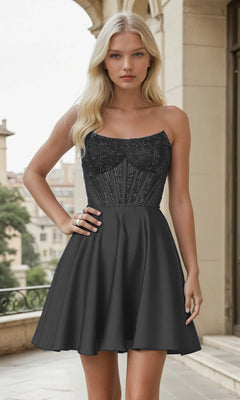 Woman wearing a black strapless short dress with beaded top in an urban setting