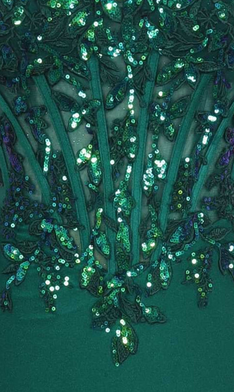Close-up of emerald green fabric with sheer and sequin detailing.