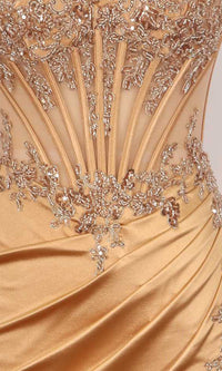 Close-up view of gold dress with a sheer embroidered corset bodice.