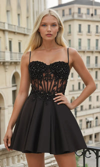 Woman wearing a black dress with intricate detailing in an urban setting