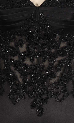 Close-up of a black beaded dress on a mannequin.