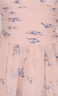 Pink dress with blue floral pattern on a plain background