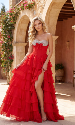 A woman in the PromGirl Exclusive 250203 A-Line Ruffle Prom Gown, with a beaded sweetheart neckline and high slit, poses outdoors before an arched stone building.