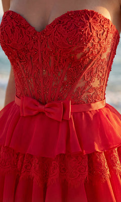A close-up of the PromGirl Exclusive 250238 chiffon and lace prom gown, featuring a red strapless design with a sheer bodice, detailed embroidery, and a fabric bow at the waist.