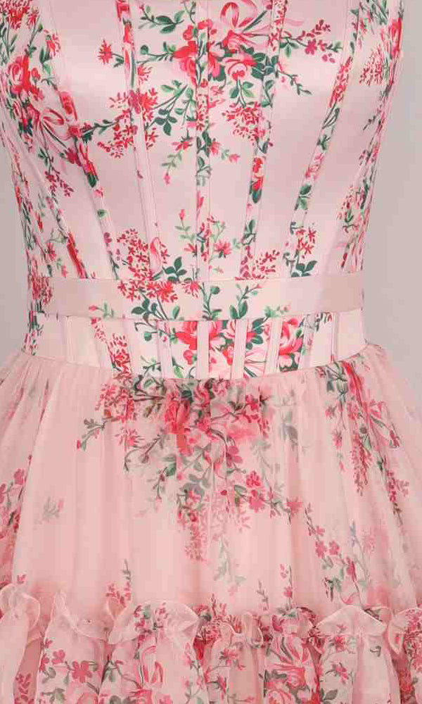 Close-up of the PromGirl Exclusive 250240 long prom dress with a floral print, fitted bodice, vertical seams, matching belt, and ruffled tulle skirt—an elegant choice for prom.