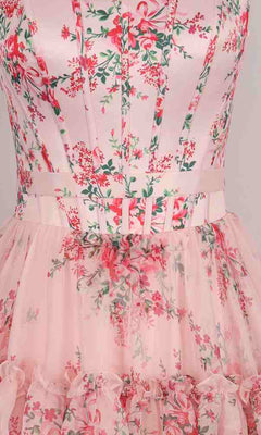Close-up of the PromGirl Exclusive 250240 long prom dress with a floral print, fitted bodice, vertical seams, matching belt, and ruffled tulle skirt—an elegant choice for prom.