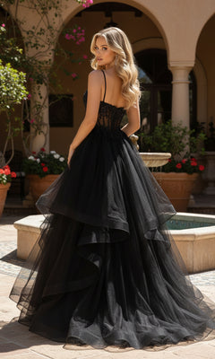 A woman wearing the PromGirl Exclusive 250241, a long high-low prom dress with a layered black skirt, stands outdoors in a courtyard, looking over her shoulder.