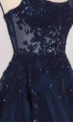 Close-up of the Long Prom Dress: PromGirl Exclusive 250245, a navy blue strapless gown with sheer mesh, floral sequin lace embroidery, and an adjustable lace-up back.