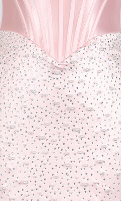 Close-up of the Short Homecoming Dress: PromGirl Exclusive 250344 featuring a pink satin corset bodice with vertical seams, adorned with scattered pearls and rhinestones.