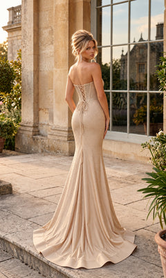 Long Corset Prom Dress: PromGirl 250370 in champagne, featuring a backless, floor-length silhouette, lace-up bodice, and an embellished rhinestone skirt.