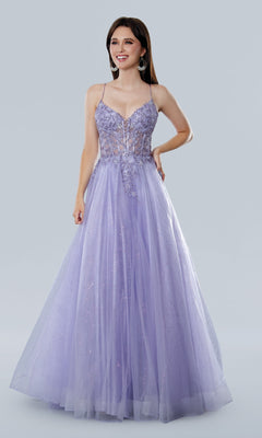 A woman smiles against a plain background in the Stella Couture 25140 Glitter Prom Ball Gown—a floor-length, sleeveless lavender dress with a fitted V-neck corset bodice featuring sequin lace embroidery and a full tulle skirt.