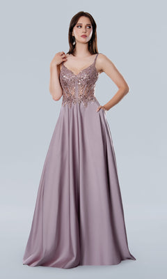 A woman models the Long Prom Dress: Stella Couture 25159—a floor-length, sleeveless lavender gown with a beaded semi-sheer bodice and flowing satin skirt, set against a plain light background.
