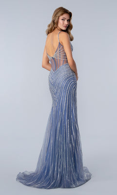 A woman models the Stella Couture 25198 long prom dress, featuring a sleeveless, floor-length fit with silver stripes, beaded embellishments, and a sheer-back silhouette against a plain light background.