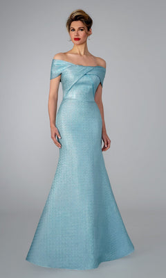 A woman poses against a plain backdrop in the Stella Couture 25329 mint long formal dress, featuring an off-the-shoulder neckline, fitted bodice, and flared skirt for an elegant evening look.