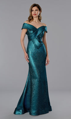 A woman poses against a gray background in the Stella Couture 25365 long formal dress—a teal, floor-length, off-the-shoulder mermaid gown with a fitted bodice and flared skirt.