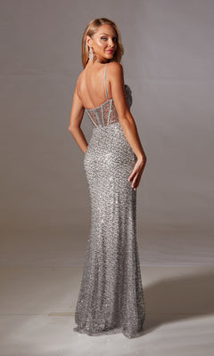 A woman models the Long Sequin Corset Prom Dress: Aerie Couture 253—silver, floor-length with spaghetti straps—posing with her back slightly turned to the camera against a plain background.