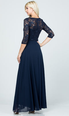 A woman with straight blonde hair and high heels faces away, wearing the Plus-Size A-Line Long Formal Dress with Sleeves in navy blue, featuring a v-neck lace bodice, three-quarter sleeves, and an a-line skirt.