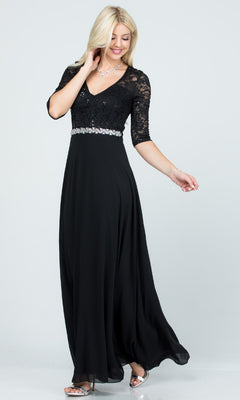 A woman models the Plus-Size A-Line Long Formal Dress with lace sleeves, a decorative waistband, and a flowing black skirt, paired with silver heels against a plain light background.