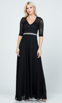 A woman wears the Sleeved V-Neck Long A-Line Formal Dress 25434, featuring black sequin lace, lace sleeves, a V-neckline, and a rhinestone-embellished waist.