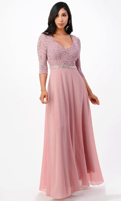 A woman wears the Sleeved V-Neck Long A-Line Formal Dress 25434, featuring sequin lace, lace sleeves, and a rhinestone waistline, standing against a plain white background.