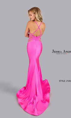 A woman stands against a plain light gray background wearing the Jessica Angel 2586 Open-Back Sheer Long Prom Dress in bright pink, featuring a fitted silhouette with crisscross straps and an open-back design.