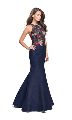 A woman poses against a white background in the La Femme 25885 Navy Blue Long Prom Dress, featuring a mermaid silhouette and sleeveless, floral embroidered bodice.