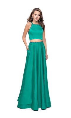A woman models the La Femme 25978 jade green two-piece prom dress, featuring a sleeveless, floor-length design with beaded trim, against a plain white background.