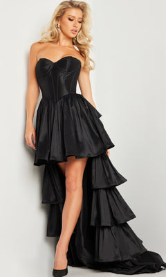 A woman in the Jovani Strapless High-Low Taffeta Prom Dress 26006 with a sweetheart neckline and ruffled train, paired with black heels, stands against a light background.