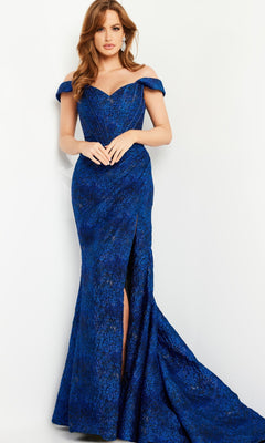 A woman models the Jovani 26017 Cobalt Blue Long Formal Dress, featuring an off-the-shoulder style and thigh-high slit, against a plain backdrop.