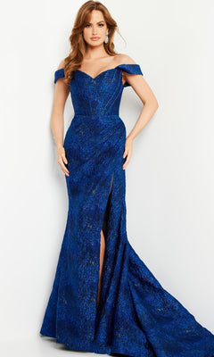 A woman poses against a white background in the Jovani 26017 Cobalt Blue Long Formal Dress, an off-the-shoulder gown with a sweetheart neckline, floor-length hem, and high leg slit.