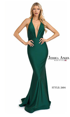 A woman wears the Jessica Angel 2604 Long Prom Dress in Hunter, featuring a stretch jersey halter design, plunging neckline, fitted silhouette, and slight train.