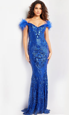A woman stands against a plain white background wearing the Jovani Feathered Long Sequin Prom Dress 26041—an off-the-shoulder, fitted, floor-length blue gown with feathered sleeves and shimmering sequins.