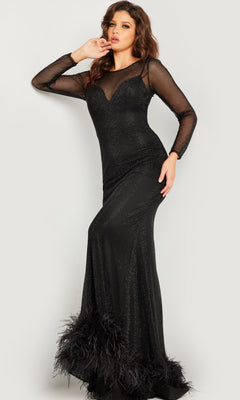 A woman models the Jovani Long Sleeve Long Black Formal Dress 26047, featuring mesh sleeves and feather-accented hem, highlighting the gown's elegant designer style against a plain light background.
