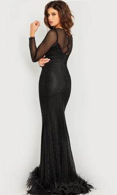 A woman models the Jovani Long Sleeve Long Black Formal Dress 26047, featuring mesh sleeves and a feathered hem, as she stands with her back turned and looks over her shoulder against a plain background.